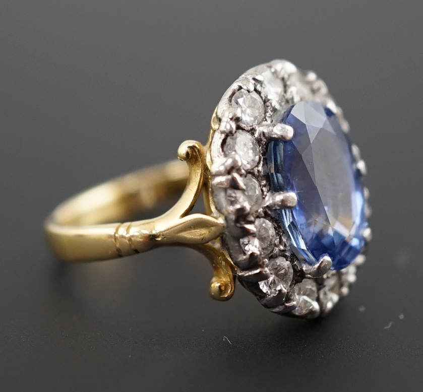 An 18ct gold, sapphire and diamond set oval cluster ring